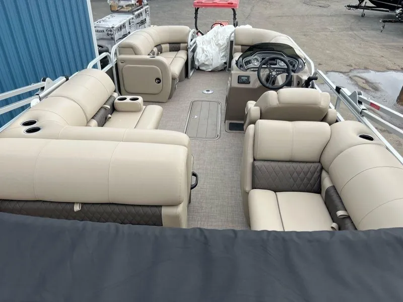 Slide: The Image of 2023 Sun Tracker PARTY BARGE® 22 RF XP3 interior with beige seating and steering console. - 5