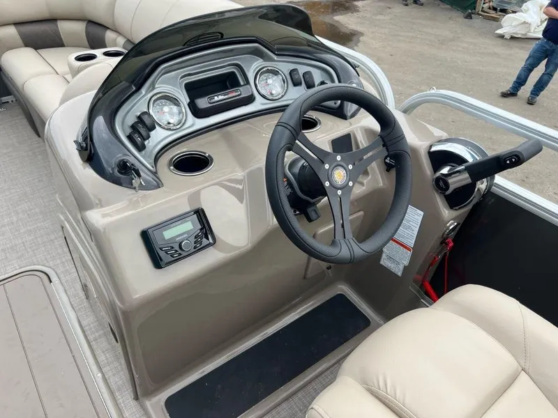 Slide: The Image of 2023 Sun Tracker PARTY BARGE® 22 RF XP3 boat dashboard and steering wheel. - 7