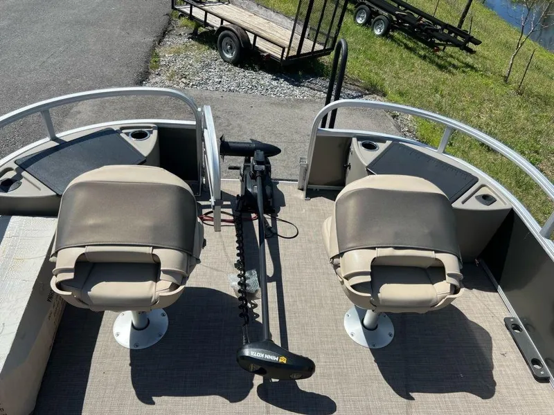 Slide: The Image of 2023 Sun Tracker FISHIN' BARGE® 22 DLX fishing boat with dual seats and trolling motor. - 3