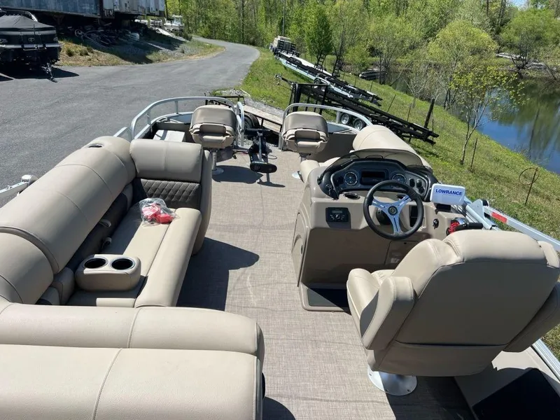 Slide: The Image of 2023 Sun Tracker FISHIN' BARGE® 22 DLX pontoon boat interior with beige seating. - 5