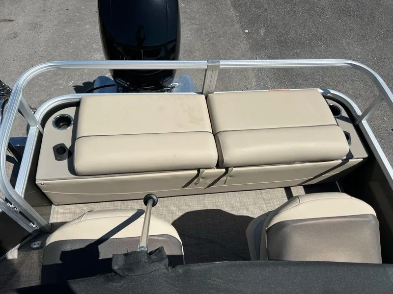 Slide: The Image of 2023 Sun Tracker FISHIN' BARGE® 22 DLX boat interior with beige seating and cup holders. - 9
