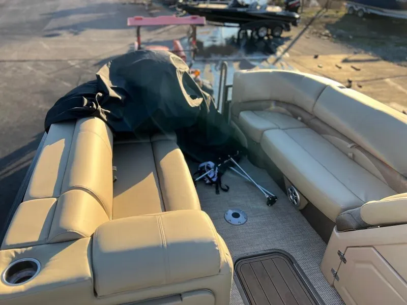 Slide: The Image of 2023 Regency 230 DL3 boat interior with beige seating and deck. - 10