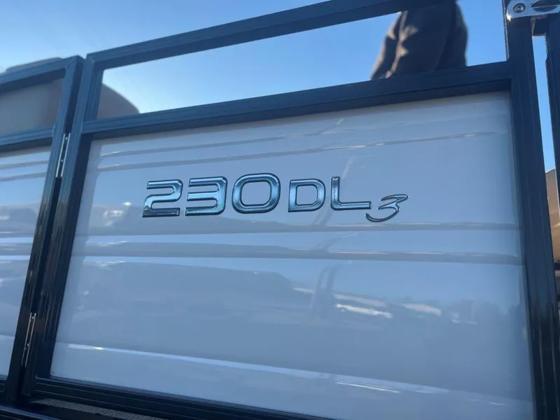 Slide: The Image of 2023 Regency 230 DL3 boat model emblem in close-up. - 4