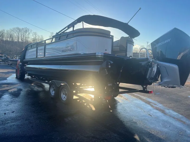 Slide: The Image of 2023 Regency 230 DL3 pontoon boat on a trailer with a Mercury outboard motor. - 5