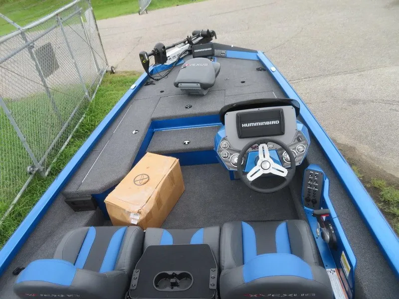 Slide: The Image of 2023 Vexus AVX 181 boat interior with Humminbird electronics and blue seating. - 4