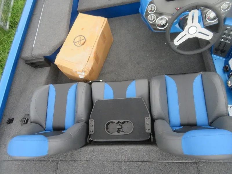 Slide: The Image of 2023 Vexus AVX 181 boat interior with blue and gray seats and a cardboard box. - 6