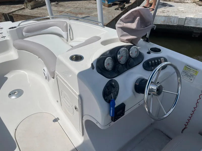 Slide: The Image of 2018 Starcraft 2000 OB Limited boat dashboard and seating area. - 13