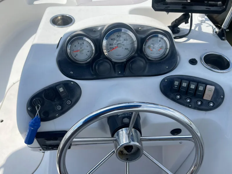 Slide: The Image of 2018 Starcraft 2000 OB Limited boat dashboard with steering wheel and gauges. - 14