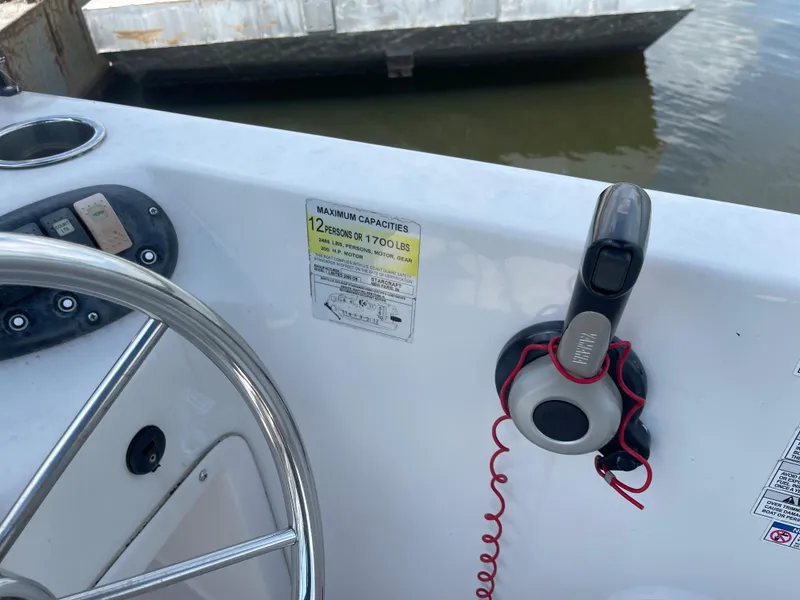 Slide: The Image of 2018 Starcraft 2000 OB Limited boat helm with steering wheel and throttle control. - 17