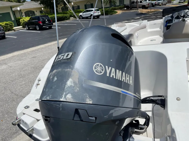 Slide: The Image of 2018 Starcraft 2000 OB Limited with Yamaha 150 outboard motor in parking lot. - 2