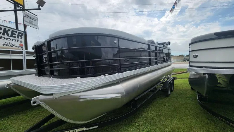 Slide: The Image of 2023 Veranda VISTA22RC Bi-Toon pontoon boat displayed outdoors on a trailer. - 2