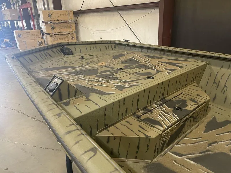 Slide: The Image of 2023 SeaArk RiverCat 200 Side Console boat interior in warehouse. - 6