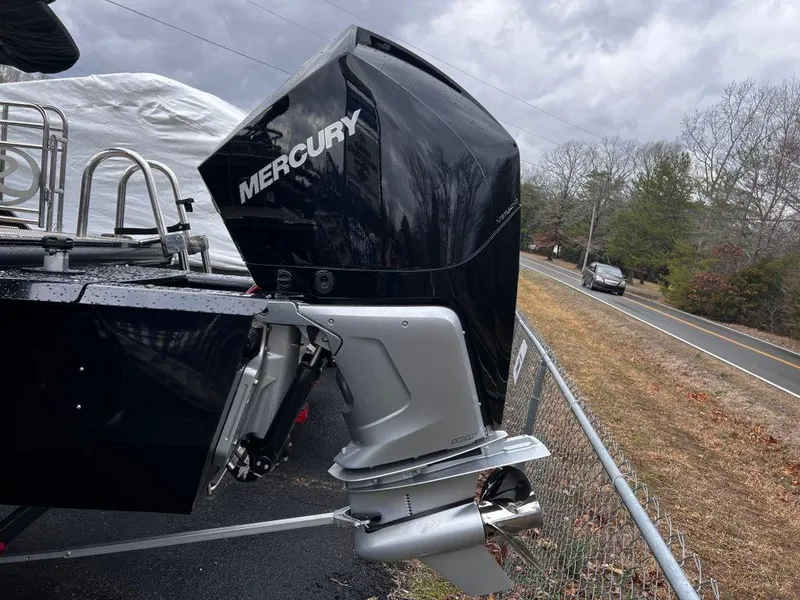 Slide: The Image of 2023 Regency 250 LE3 boat with Mercury outboard motor on a cloudy day. - 13