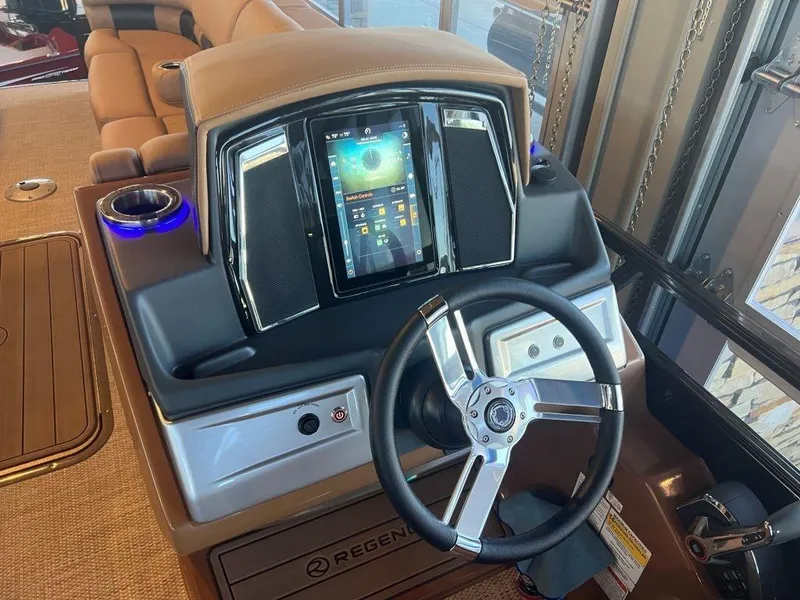 Slide: The Image of 2023 Regency 250 LE3 boat dashboard with touchscreen and steering wheel. - 15