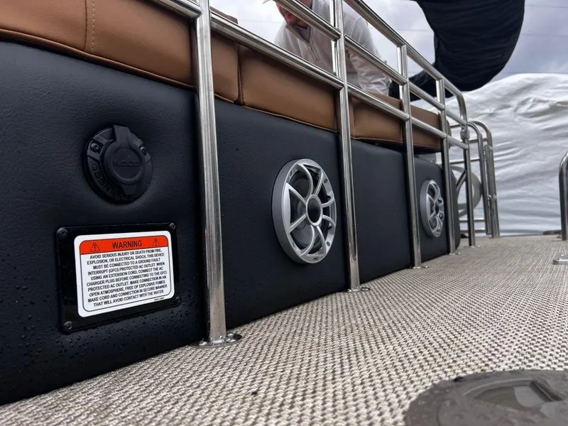 Slide: The Image of 2023 Regency 250 LE3 boat deck with speakers and safety warning label. - 18