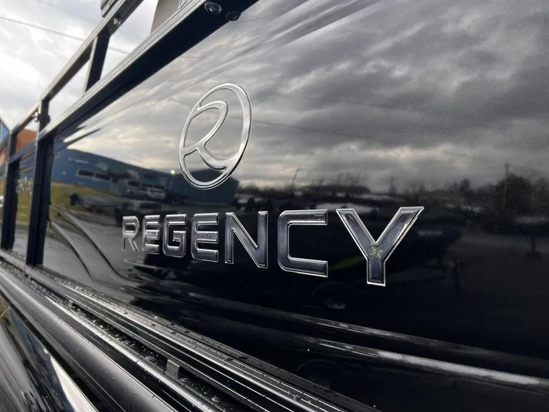Slide: The Image of 2023 Regency 250 LE3 logo on sleek black surface, reflecting cloudy sky. - 20