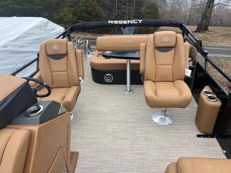 Slide: The Image of Luxurious 2023 Regency 250 LE3 pontoon boat interior with tan leather seating. - 5