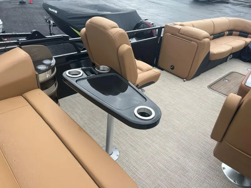 Slide: The Image of Luxurious 2023 Regency 250 LE3 boat interior with tan seating and cup holders. - 9