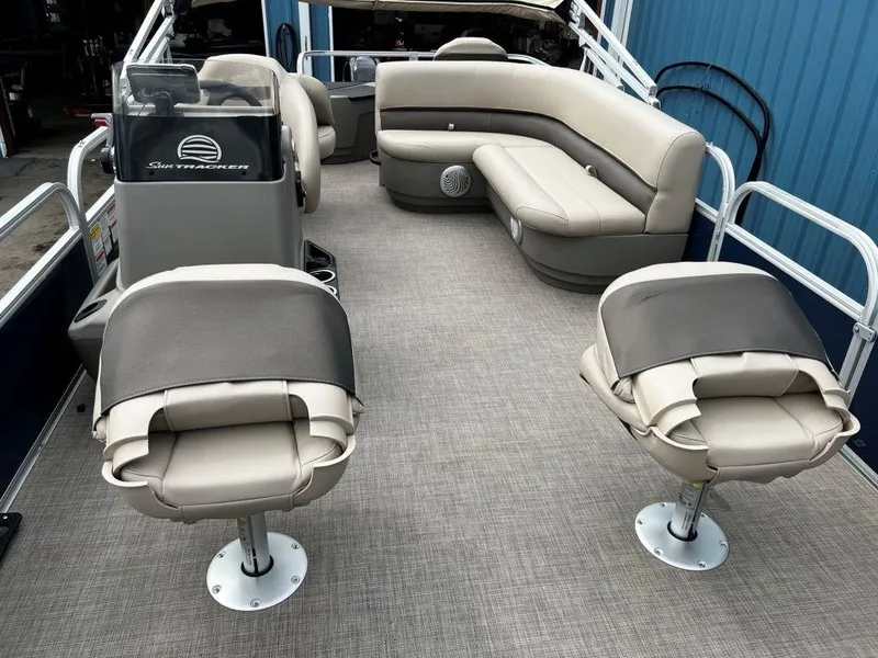 Slide: The Image of 2023 Sun Tracker BASS BUGGY® 18 DLX pontoon boat interior with seating and steering console. - 11