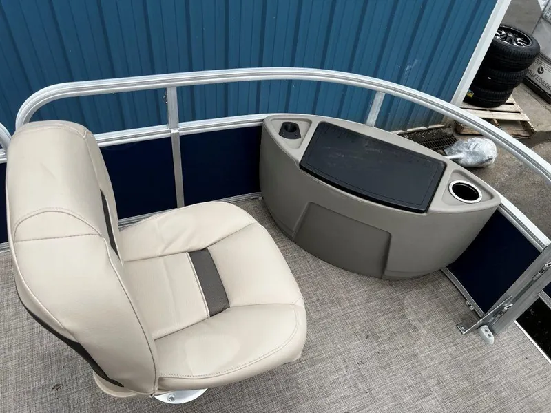 Slide: The Image of 2023 Sun Tracker BASS BUGGY® 18 DLX boat interior with beige seating and console. - 7