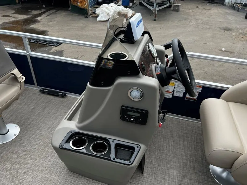 Slide: The Image of 2023 Sun Tracker BASS BUGGY® 18 DLX boat console with steering wheel and cup holders. - 9