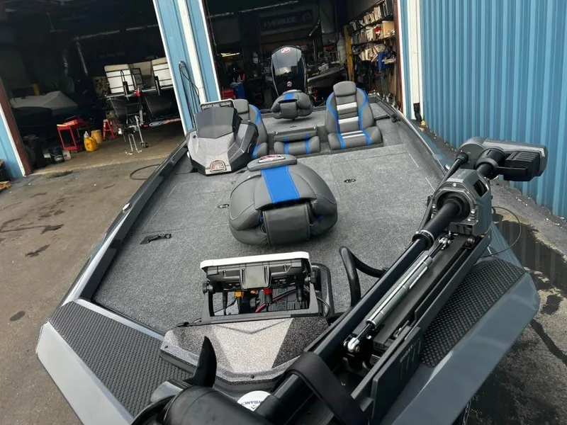 Slide: The Image of 2023 Ranger RT198P fishing boat in a garage, featuring modern equipment and seating. - 1