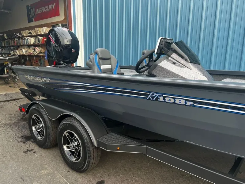 Slide: The Image of 2023 Ranger RT198P fishing boat with Mercury outboard motor in a garage. - 9