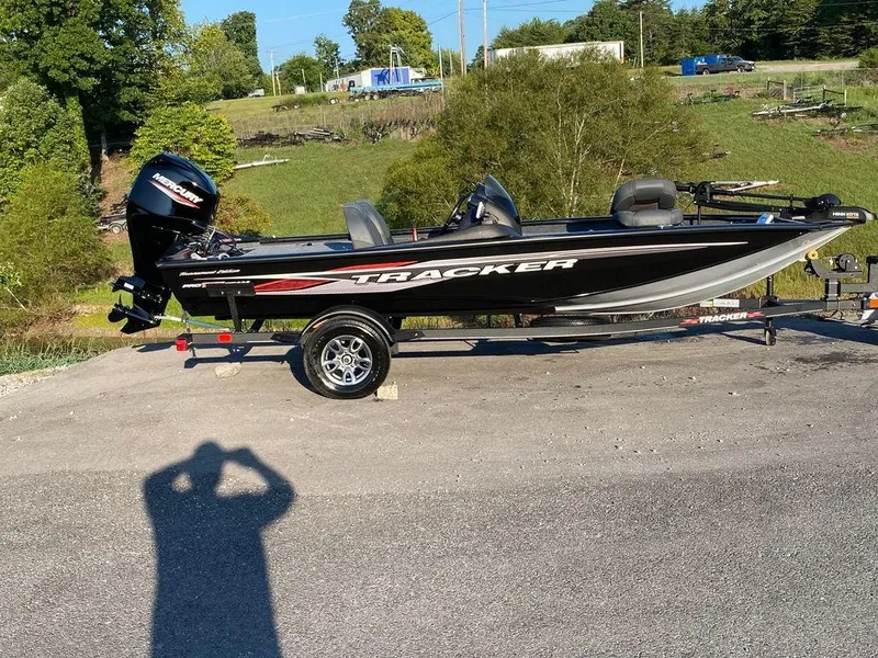 The Image of 2023 Tracker Pro Team 175 TF® fishing boat on a trailer in a rural setting. - 0