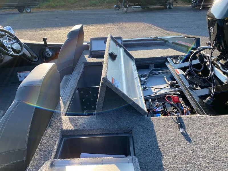 Slide: The Image of 2023 Tracker Pro Team 175 TF® boat interior with open storage compartments. - 5