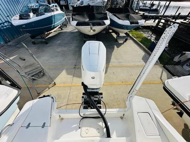 Slide: The Image of 2023 Boston Whaler 280 Dauntless boat docked with outboard motor, surrounded by other boats. - 10