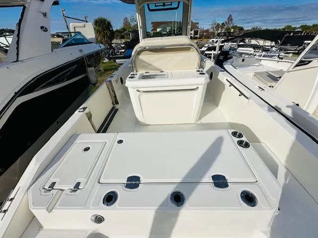 Slide: The Image of 2023 Boston Whaler 280 Dauntless boat interior with seating and storage compartments. - 11