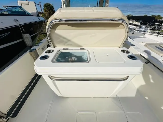 Slide: The Image of 2023 Boston Whaler 280 Dauntless boat interior with seating and storage area. - 12