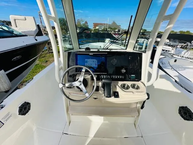 Slide: The Image of 2023 Boston Whaler 280 Dauntless boat cockpit with steering wheel and navigation system. - 13