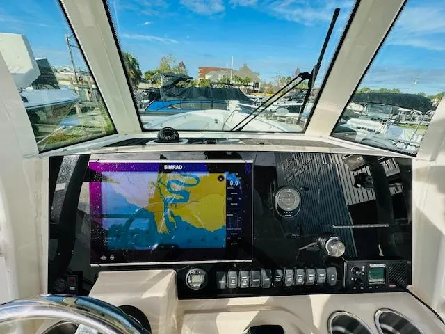 Slide: The Image of 2023 Boston Whaler 280 Dauntless dashboard with navigation display and controls. - 17
