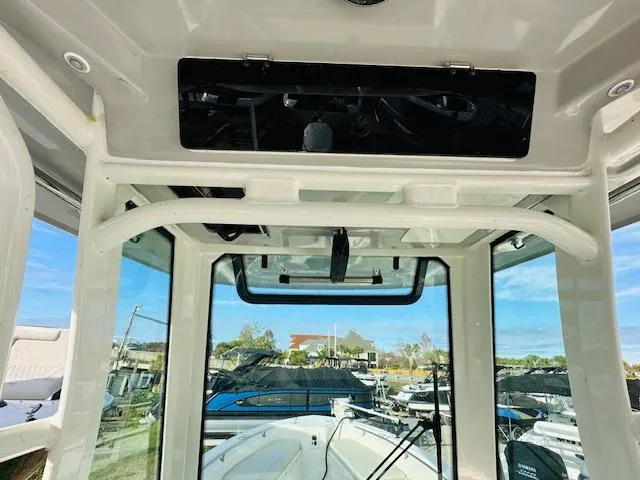 Slide: The Image of Interior view of 2023 Boston Whaler 280 Dauntless boat, showcasing helm and windshield. - 19