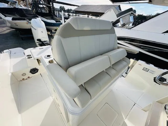 Slide: The Image of 2023 Boston Whaler 280 Dauntless boat interior with cushioned seating and modern design. - 21