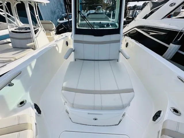 Slide: The Image of 2023 Boston Whaler 280 Dauntless boat interior with cushioned seating and sleek design. - 24