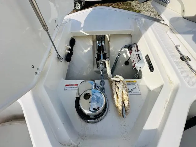 Slide: The Image of Anchor compartment of 2023 Boston Whaler 280 Dauntless boat with rope and chain. - 28