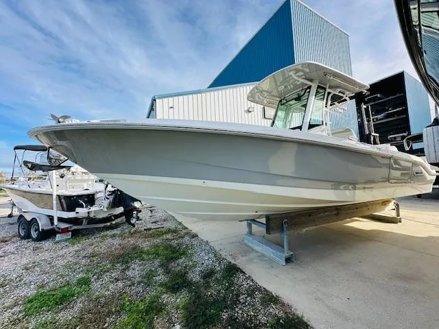 Slide: The Image of 2023 Boston Whaler 280 Dauntless boat displayed outdoors near a blue building. - 4