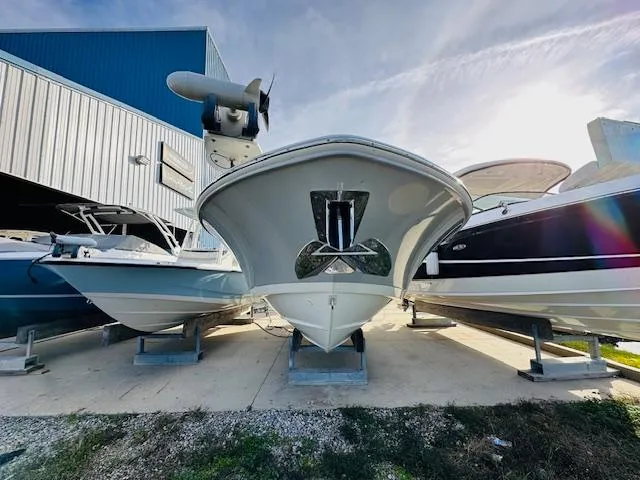 Slide: The Image of 2023 Boston Whaler 280 Dauntless boat in storage, front view, with clear sky background. - 9