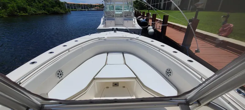 Slide: The Image of 2015 Robalo R300 Center Console boat docked on a sunny day. - 11