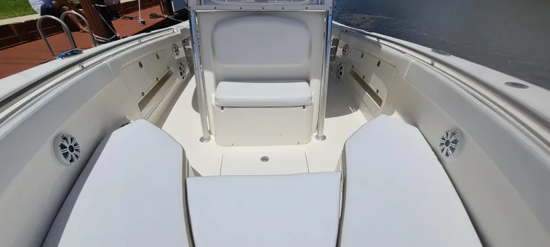 Slide: The Image of 2015 Robalo R300 Center Console boat interior with seating and storage compartments. - 20