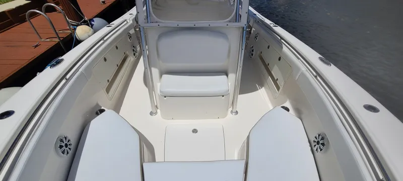 Slide: The Image of 2015 Robalo R300 Center Console boat interior with seating and storage compartments. - 21