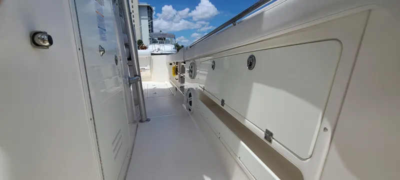 Slide: The Image of 2015 Robalo R300 Center Console boat interior with storage compartments. - 23