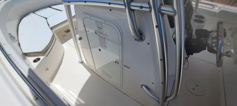 Slide: The Image of 2015 Robalo R300 Center Console boat interior with helm and storage compartments. - 24