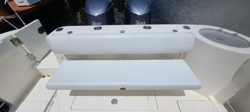 Slide: The Image of 2015 Robalo R300 Center Console boat with dual outboard engines and white seating. - 29