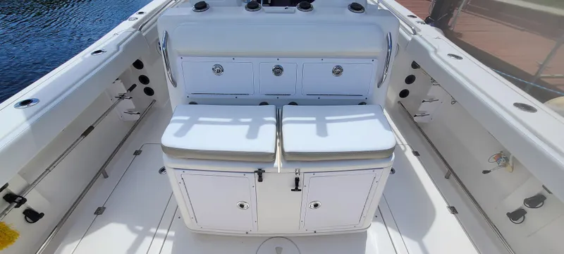 Slide: The Image of 2015 Robalo R300 Center Console boat interior with seating and storage compartments. - 3