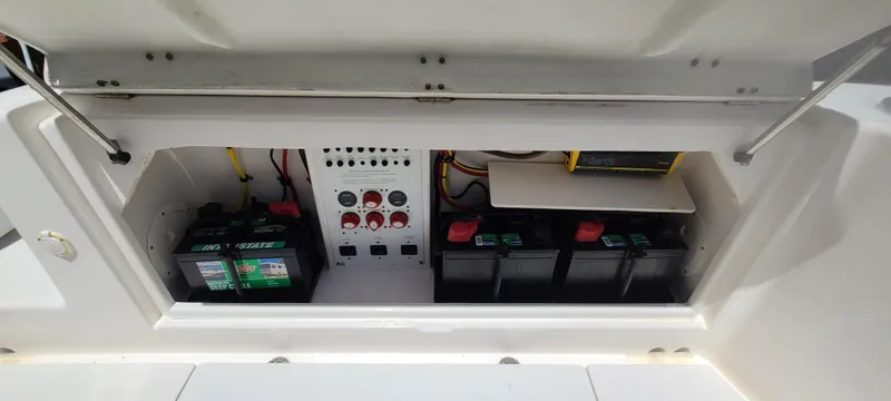 Slide: The Image of 2015 Robalo R300 Center Console battery compartment and control panel. - 30