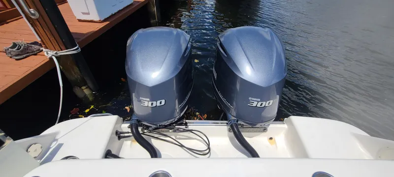 Slide: The Image of Twin outboard engines on a 2015 Robalo R300 Center Console boat. - 32