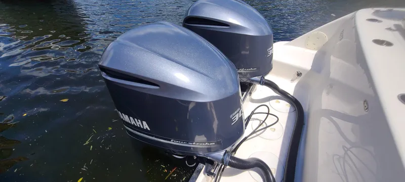 Slide: The Image of 2015 Robalo R300 Center Console with twin Yamaha outboard engines. - 33